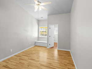 Empty room with a textured ceiling, ceiling fan, and light hardwood / wood-style flooring