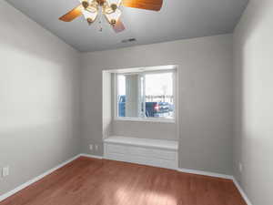 Spare room with ceiling fan and wood-type flooring