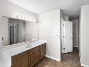 Bathroom featuring vanity and a textured ceiling