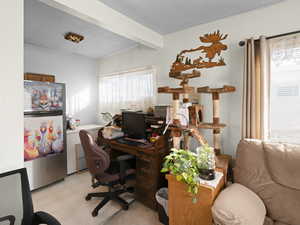 Office featuring beamed ceiling and a textured ceiling