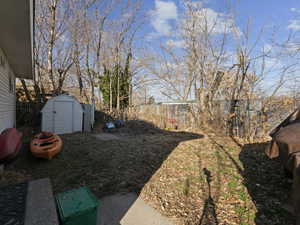 View of yard with a storage shed