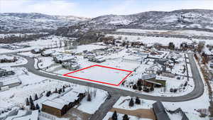 Snowy aerial view featuring a mountain view