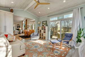 Living room with wooden ceiling, ceiling fan, vaulted ceiling with beams, and light wood-type flooring