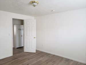 Unfurnished bedroom featuring hardwood / wood-style floors