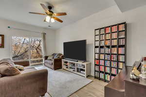 Living room featuring ceiling fan and light hardwood / wood-style flooring