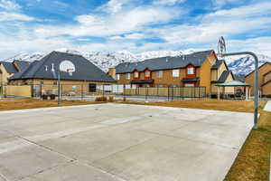 View of sport court featuring a yard, a mountain view, and a gazebo