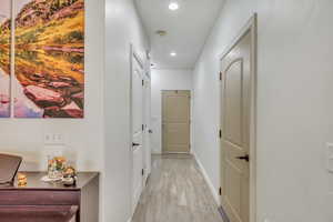 Corridor with light hardwood / wood-style flooring