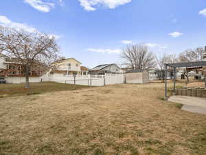 Spacious yard with a pergola, patio, and shed