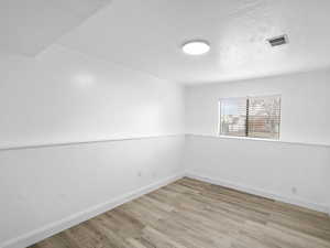 Spare room featuring light wood-type flooring