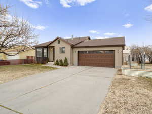 Single story home with a front lawn and oversized garage