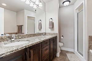 Primary Bathroom with double sinks and soaking tub and stand alone shower Bathroom with toilet, vanity, and walk in shower