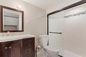 Bathroom on lower level/basement. Shower only, no tub. Bathroom with toilet, a shower with door, and vanity