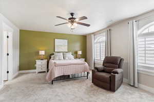 Large primary bedroom, that faces to the south. NEW Carpeted & thick pad.  bedroom featuring ceiling fan