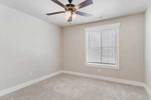 Bedroom #2 upstairs with ceiling fan, light colored carpet, and plenty of natural light