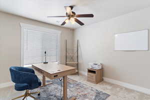 Bedroom currently used as Home office with ceiling fan and light carpet