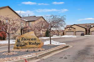 Community sign with a garage in background. Tuscan Ridge development