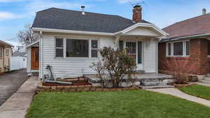 Bungalow-style home with a front yard