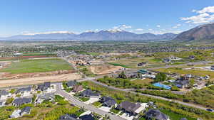 Aerial overview of property's location featuring a mountainous background and nearby suburban area