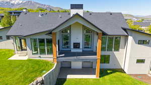Rear view of property featuring a chimney, stucco siding, and a mountain view