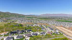 Aerial overview of property's location with nearby suburban area and a mountain backdrop