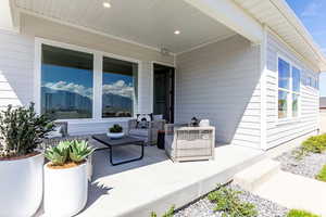 View of East facing covered patio with outdoor lounge area. Photo of Finland Model Home not subject property