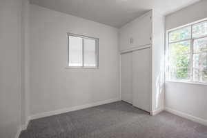 Unfurnished bedroom with a closet and carpet