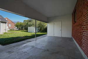 View of patio / terrace with a shed