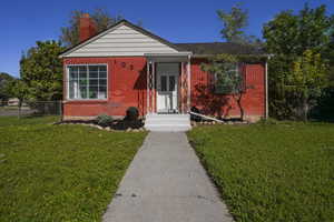 Bungalow-style home with a front lawn