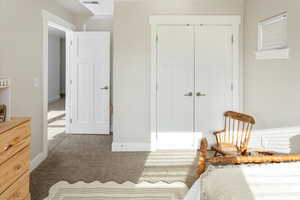 Bedroom featuring carpet floors and a closet