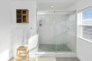 Bathroom featuring an enclosed shower and tile patterned floors