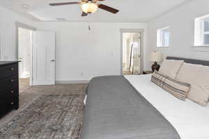 Bedroom with ceiling fan and carpet
