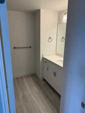 Bathroom featuring a textured ceiling, wood-type flooring, and vanity