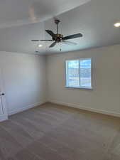 Spare room with ceiling fan and carpet floors