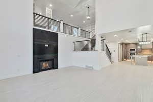 Tiled living room with a high ceiling and a fireplace