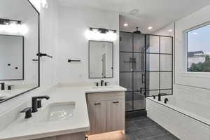 Bathroom with vanity, tile patterned flooring, and separate shower and tub