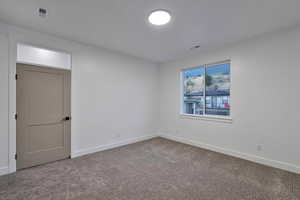 Unfurnished room with carpet