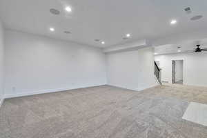 Spare room with ceiling fan and light colored carpet