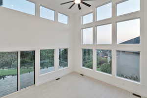 Interior space with ceiling fan and plenty of natural light