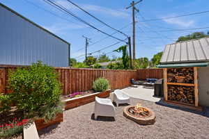 View of patio featuring an outdoor living space with a fire pit