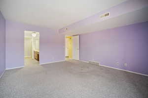 Empty room with light colored carpet