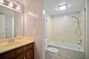 Full bathroom with toilet, shower / bathtub combination, and vanity