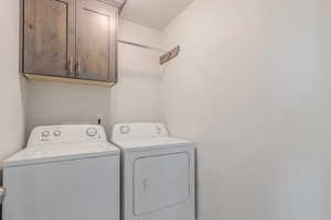 Laundry room with cabinets and independent washer and dryer