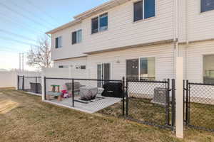 Rear view of house featuring a patio area and a lawn