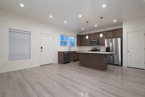 Kitchen with pendant lighting, appliances with stainless steel finishes