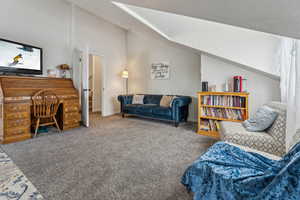 Living room with carpet flooring and lofted ceiling