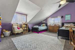 Bedroom featuring carpet, ceiling fan, and lofted ceiling