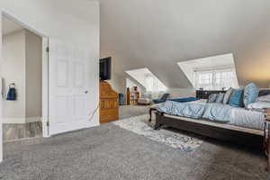 Carpeted bedroom with vaulted ceiling