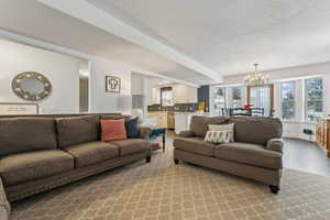 Living room featuring a textured ceiling and a chandelier