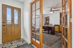 Foyer featuring a textured ceiling, dark hardwood / wood-style flooring, french doors, and ceiling fan