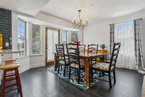 Dining area featuring a chandelier and dark hardwood / wood-style floors